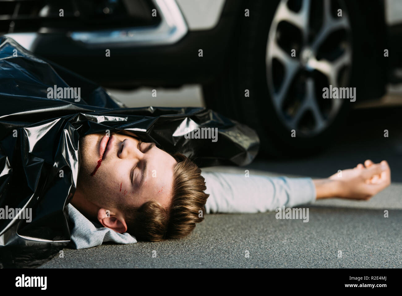 close-up view of dead body on road after traffic collision Stock Photo