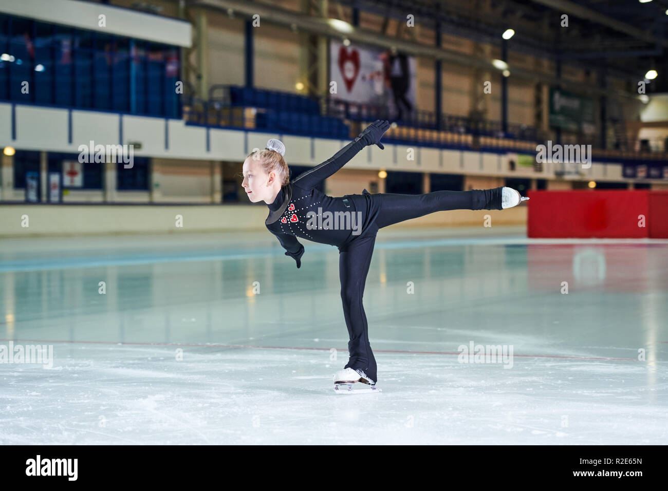 Girl Figure-Skating in Rink Stock Photo