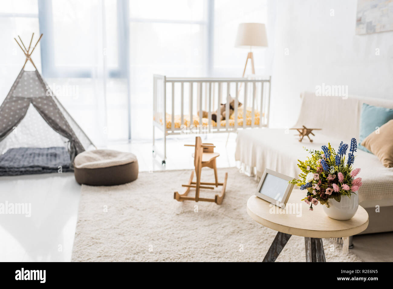 modern interior design of nursing room with crib and baby wigwam Stock Photo