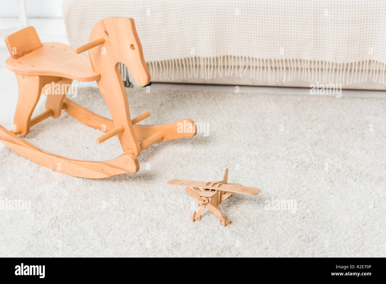 wooden horse and retro airplane toys on bedroom floor Stock Photo