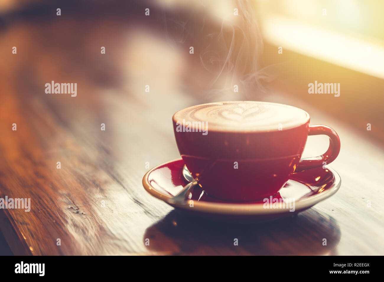 aroma morning coffee on wooden table smoke at windows vintage tone. Stock Photo