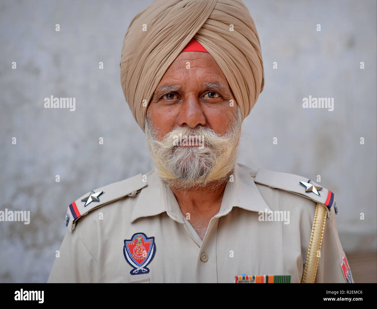 Elderly Indian Sikh policeman in uniform and grey Sikh turban (dastar). Stock Photo