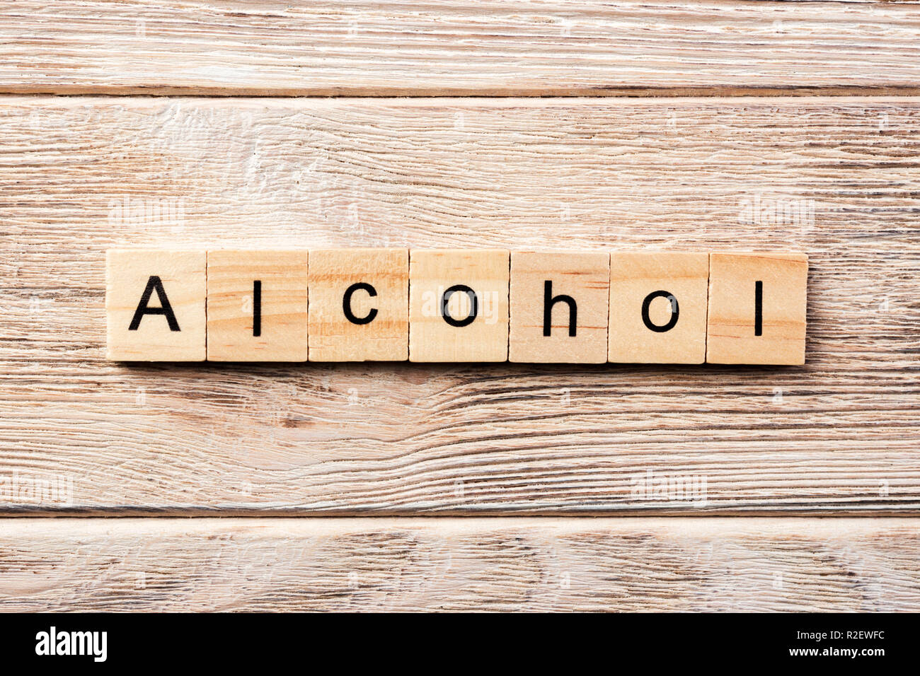 alcohol word written on wood block. alcohol text on table, concept. Stock Photo