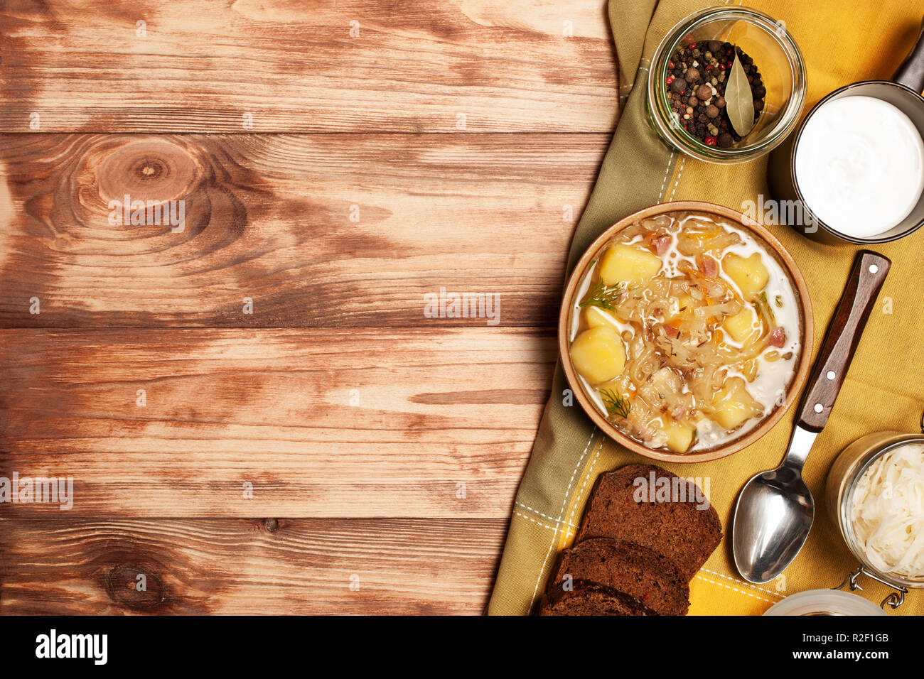 Sauerkraut soup on a wooden board.Photographed overhead on rustic wood.Copy space. Stock Photo