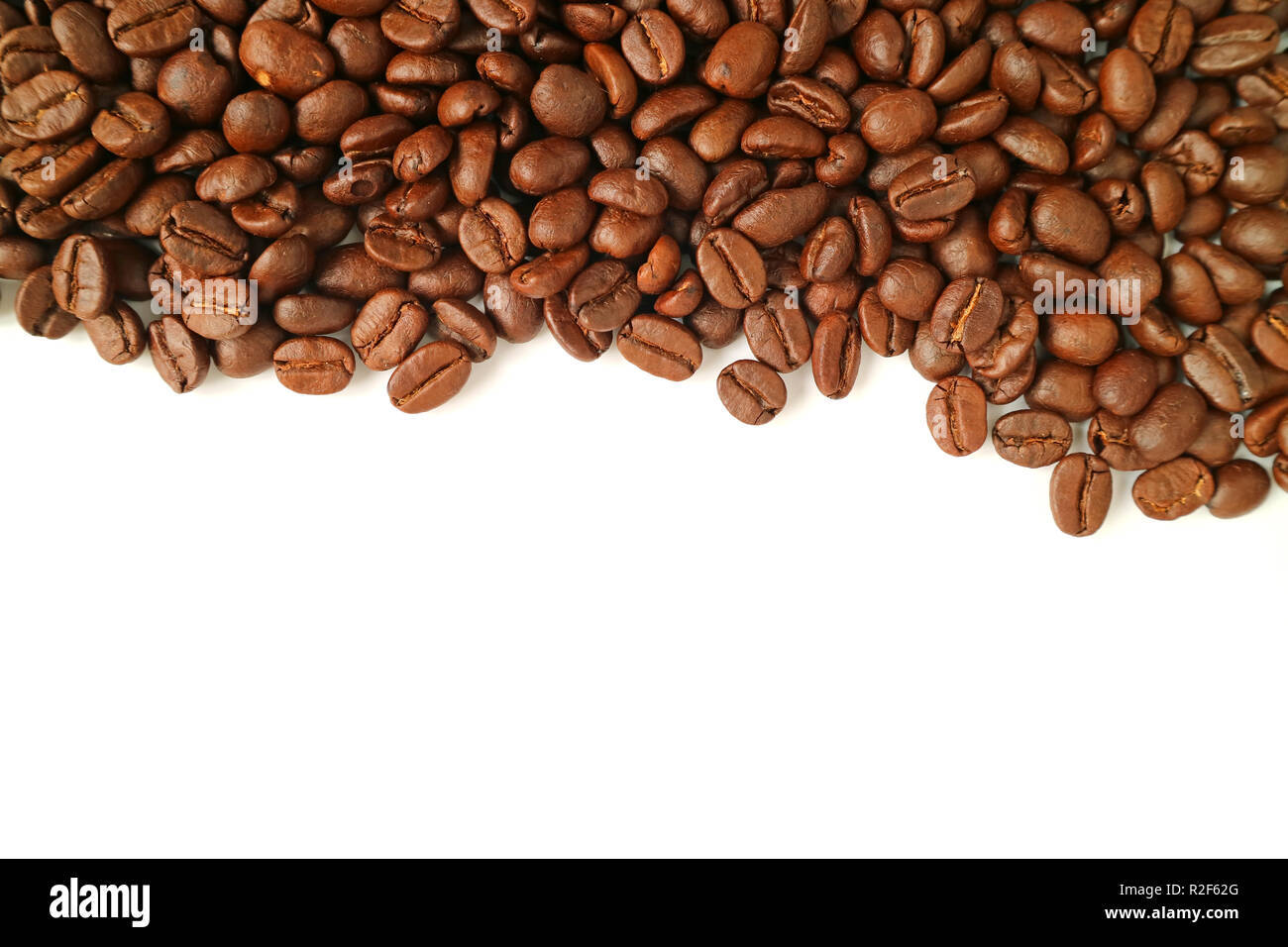 Top view of heap of roasted coffee beans isolated on white background ...