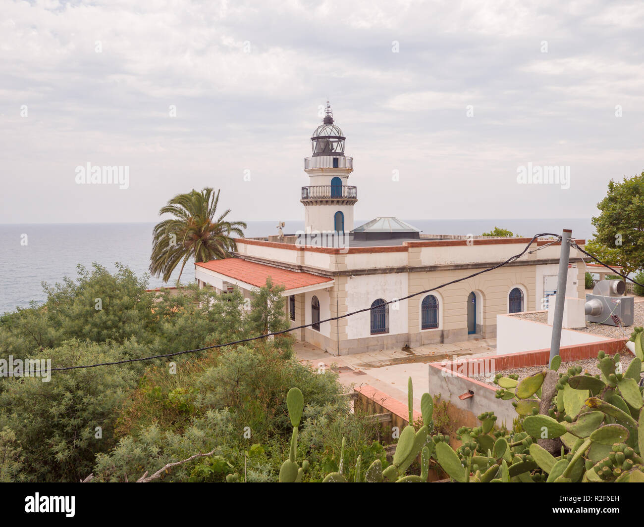 Calella Lighthouse is active lighthouse situated in coastal town of Calella in Costa del Maresme, Catalonia, Spain Stock Photo