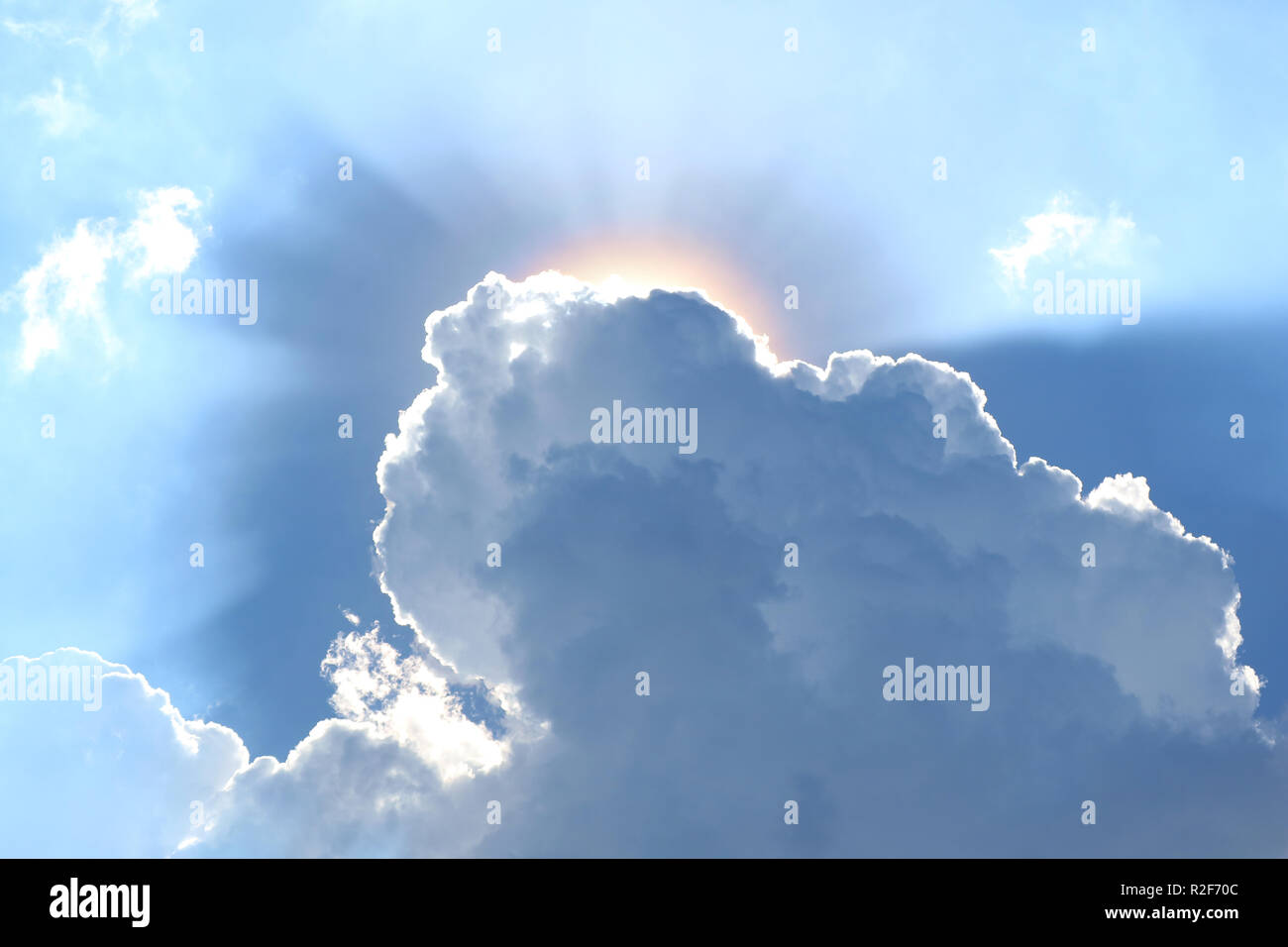 Grey clouds with the dazzling sun shining from the back Stock Photo