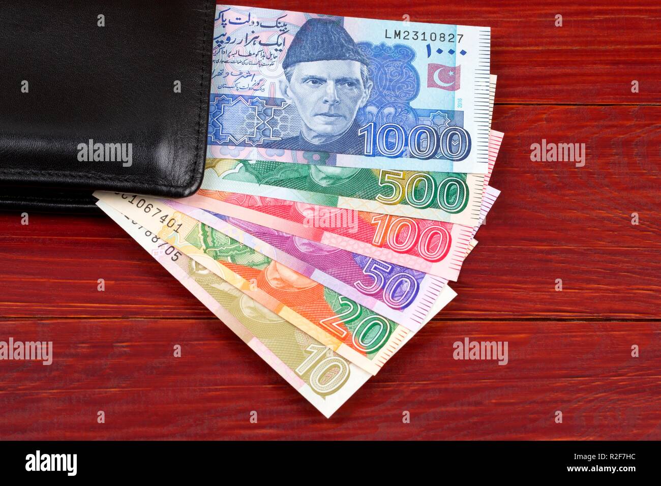 Pakistani money in the black wallet Stock Photo