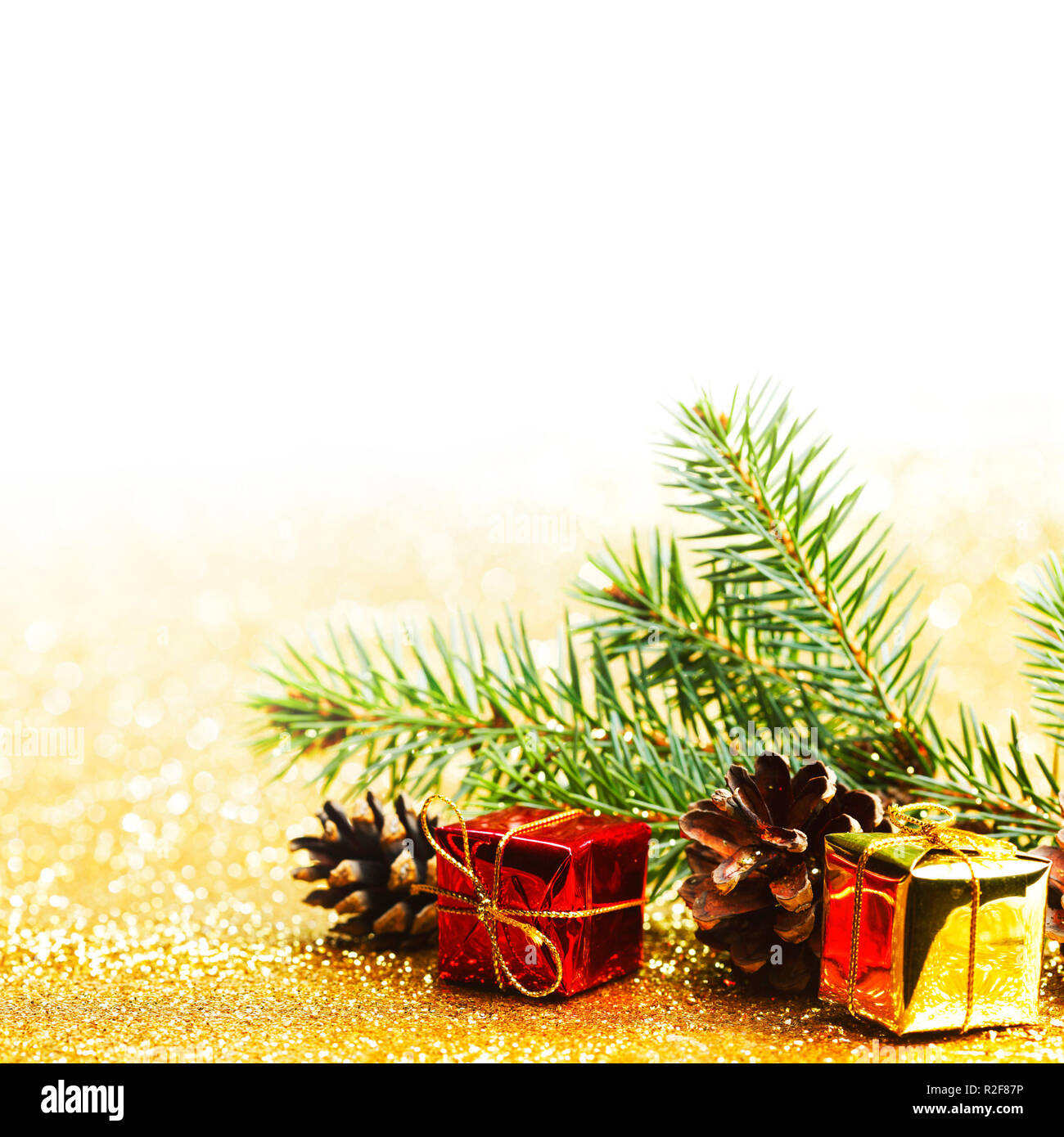 Christmas card with fir branch and decorations on golden gitter ...