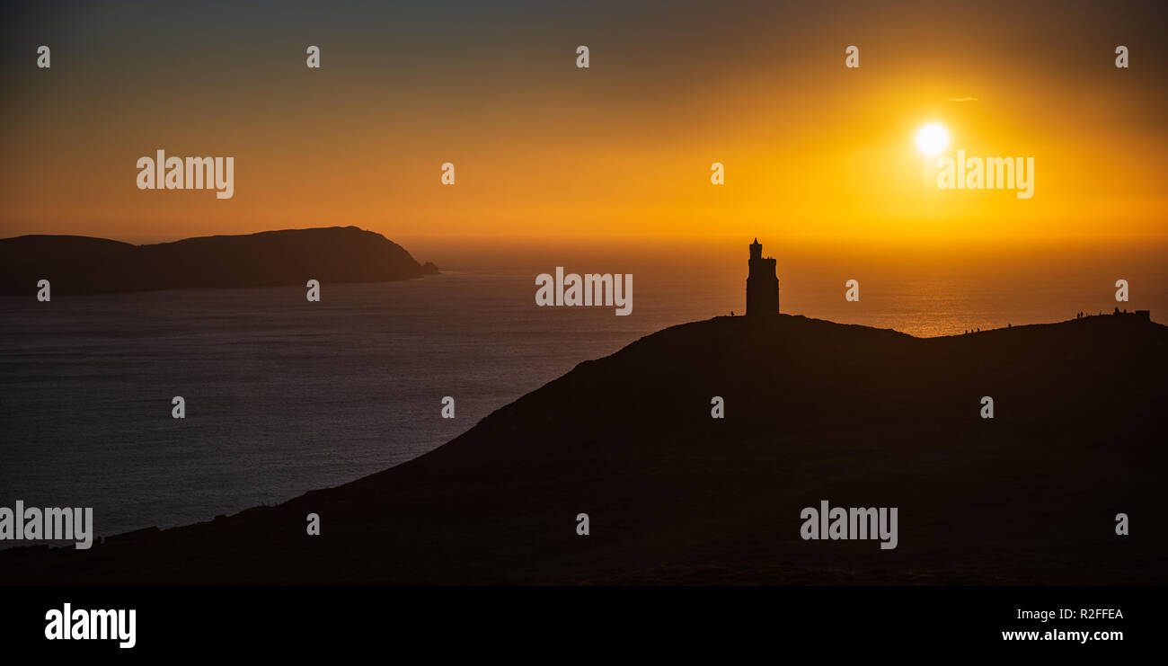 Sunset over Milner's Tower, Bradda Head, Port Erin, Isle of Man. Calf of Man in background. Stock Photo