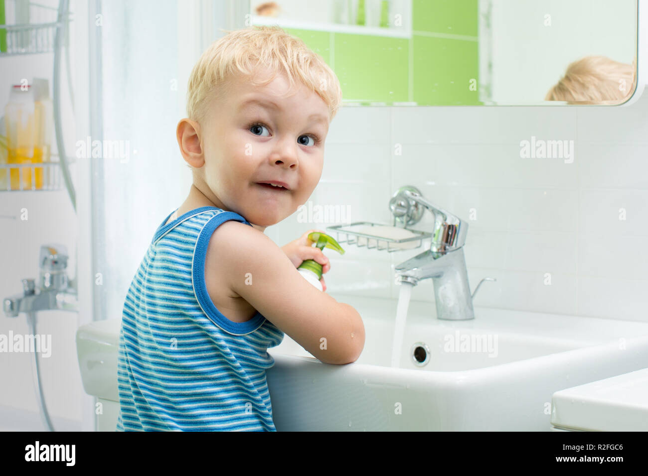 Young boy washing face at sink hires stock photography and images Alamy