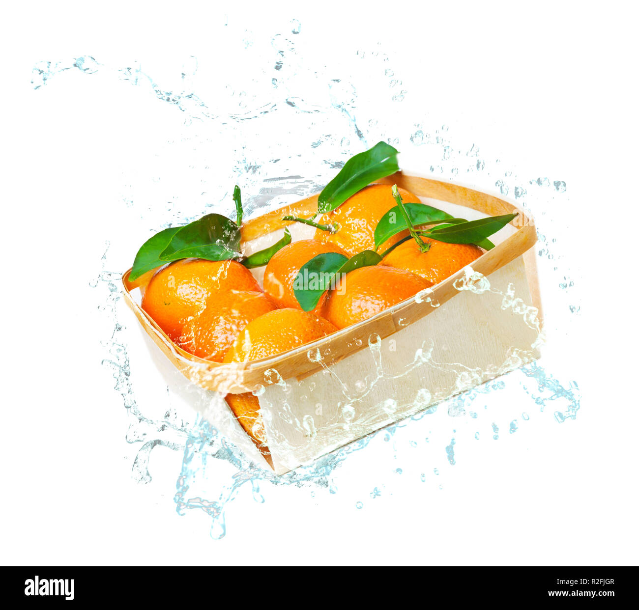 Leaf clementines in bowl, water splashes Stock Photo Alamy