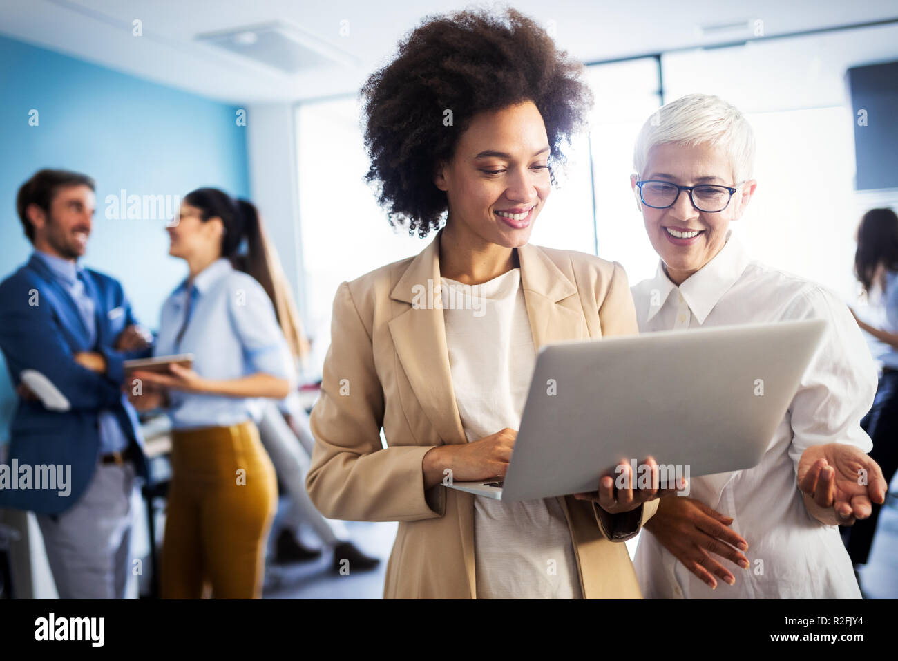 Programmers cooperating at IT company developing apps Stock Photo