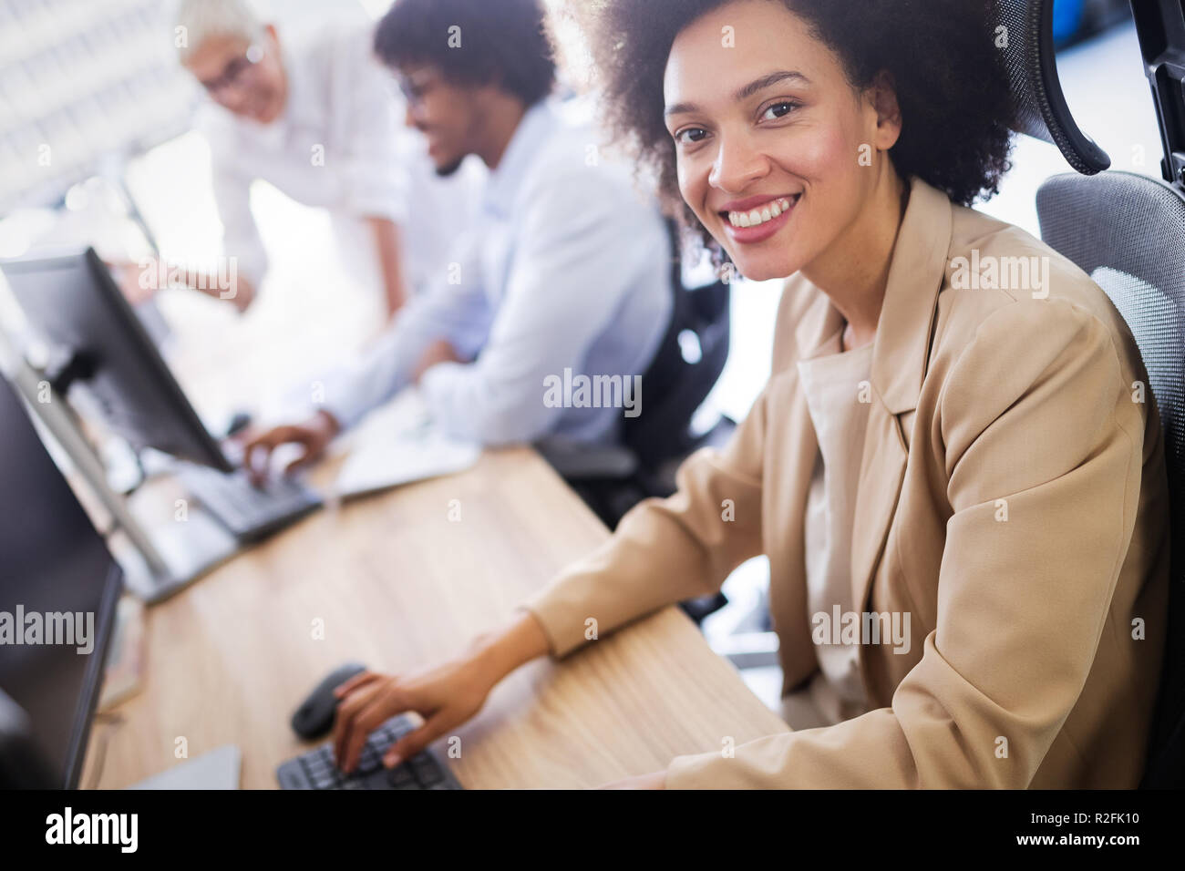 Programmers cooperating at IT company developing apps Stock Photo