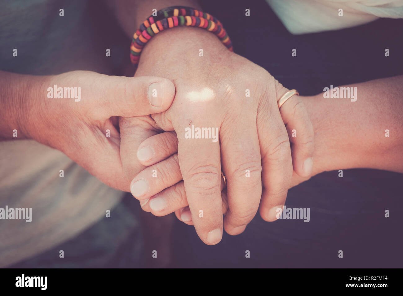 always tegether concept for a pair of elderly senior hands touching and staying together. Love moment for a life together Stock Photo