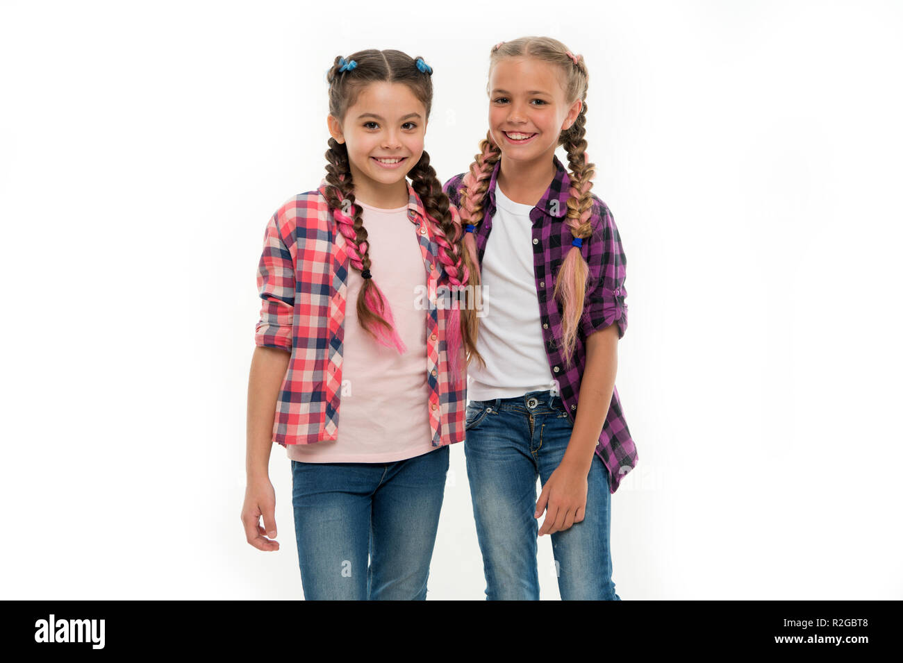 Girls friends wear similar outfits have same hairstyle kanekalon braids  white background. Sisters family look outfit. Dress similar with best  friend. Dress to match your friend. Best friend dressing Stock Photo -