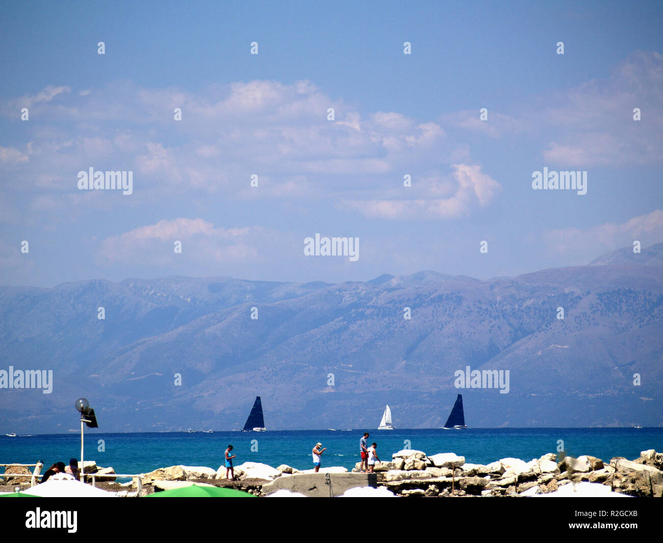Yacht regatta of the coast of Roda, Corfu, Greece, with distinctive black sales Stock Photo