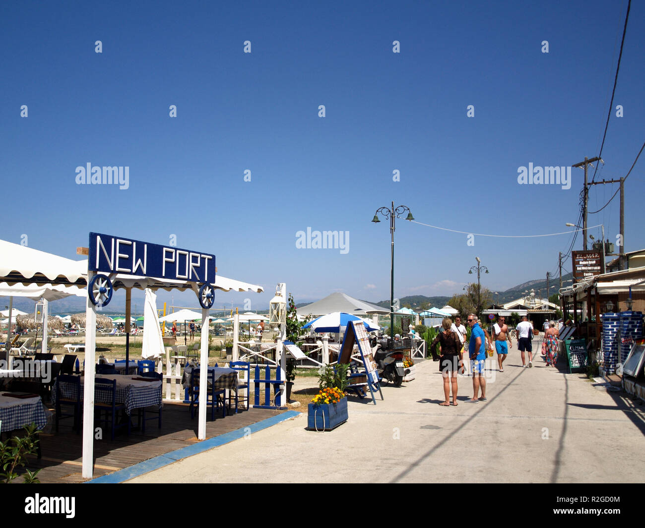 Beach road outside the New Port Restaurant in Roda, Corfu, greece Stock  Photo - Alamy