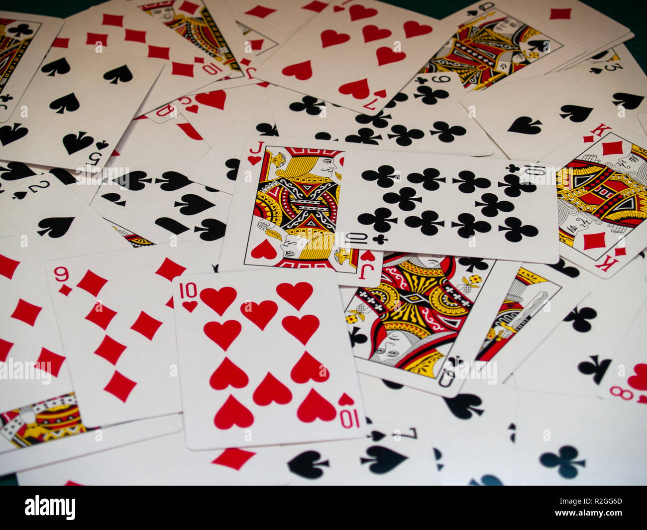 A deck of poker cards on a green rug Stock Photo