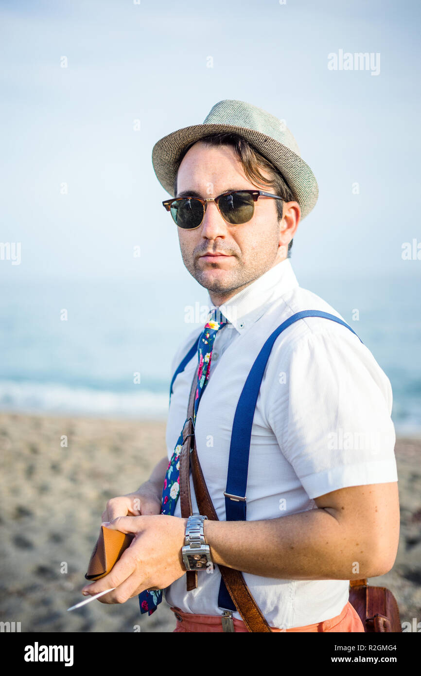 Portrait of  young man in retro style clothes on the beach Stock Photo