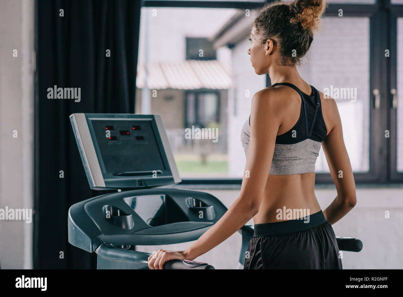 Treadmill Rear View rear view of african american female athlete on treadmill at gym Stock ...
