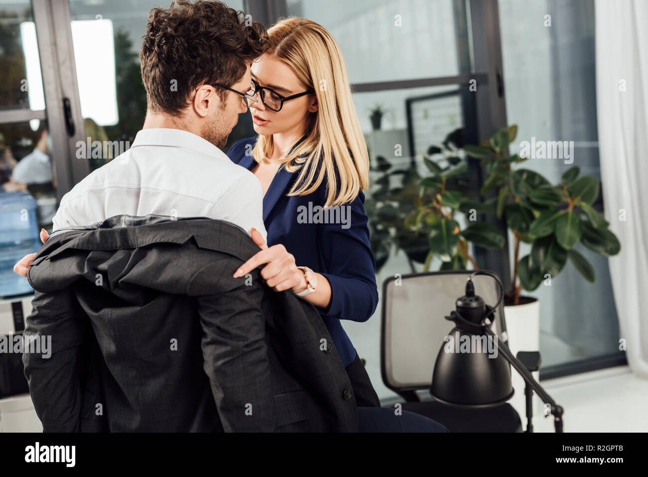 young businesswoman undressing colleague in office, flirting and office ...