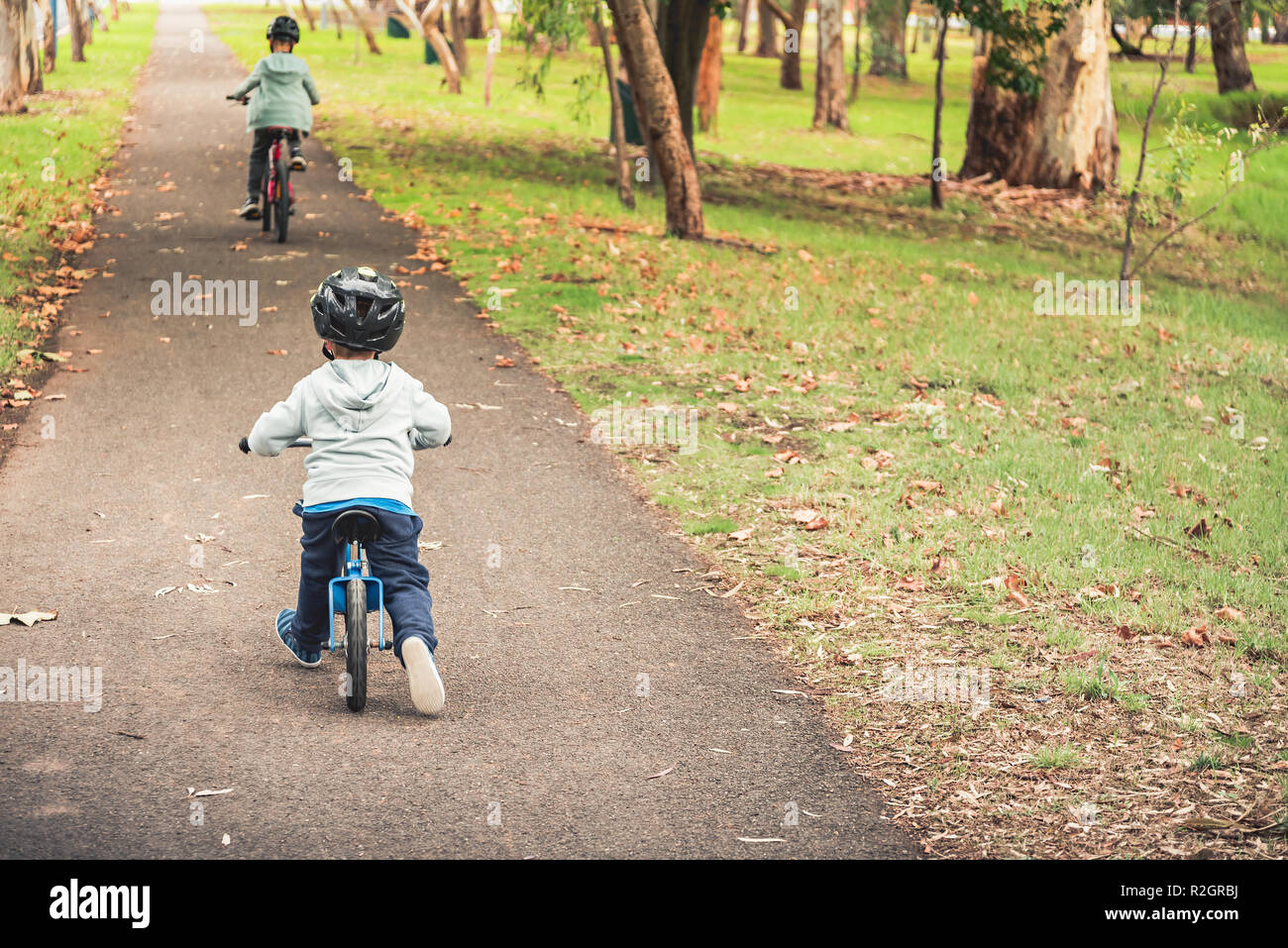 Two australian kids riding their bicycles in Adelaide, South Australia Stock Photo