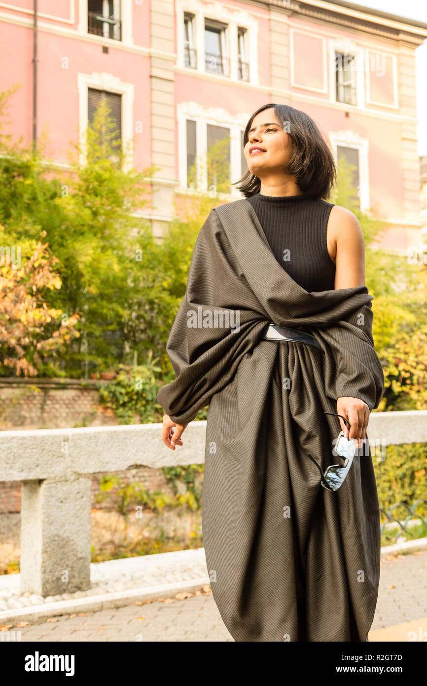 Beautiful young Indian woman posing in an urban context. Street fashion ...