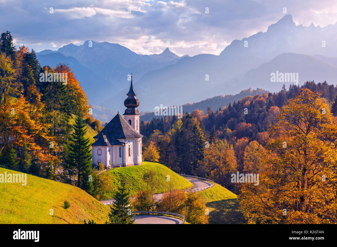 Autumn in Alps. Image of the Bavarian Alps with Maria Gern Church and Watzmann mountain during beautiful autumn sunset. Stock Photo