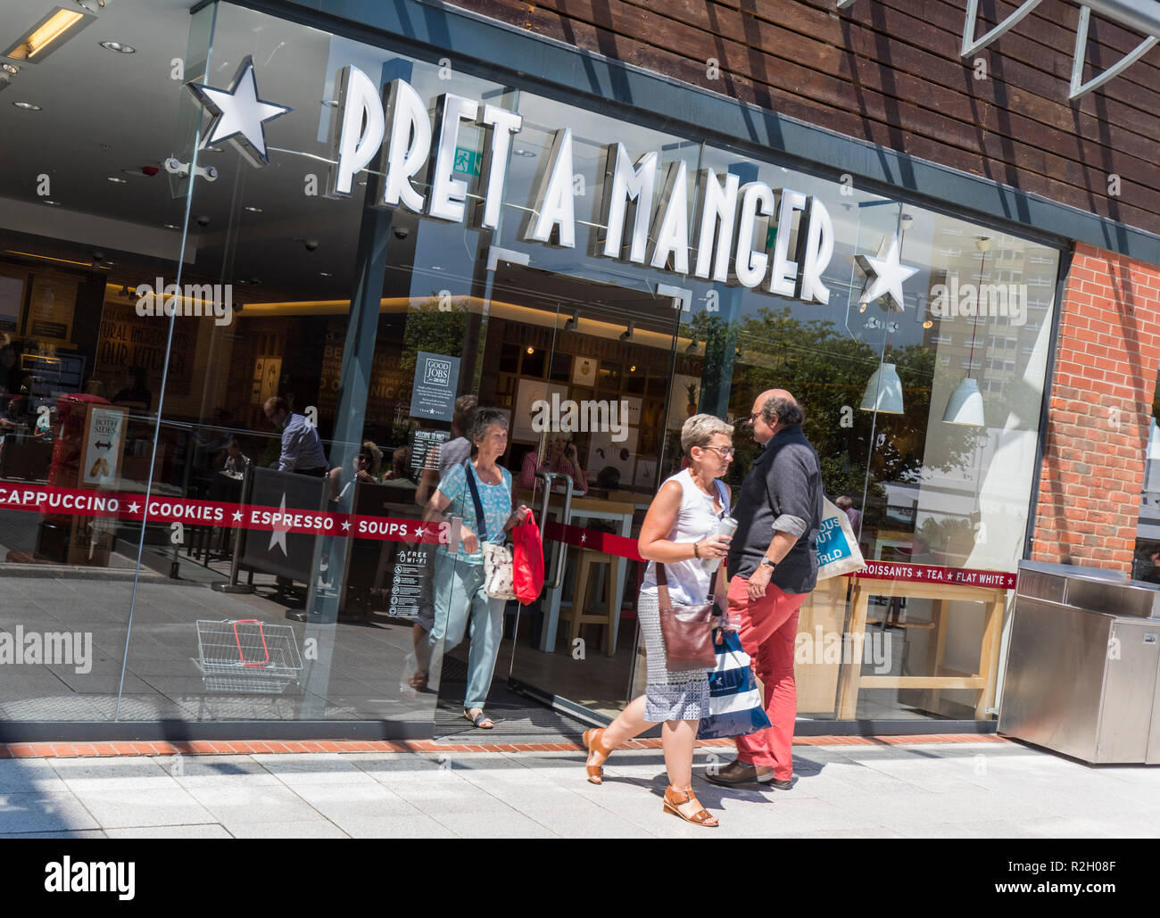 People walking in and out of the front entrance of a Pret A Manger cafe in Gunwharf Quays, Portsmouth, Hampshire. England, UK. Stock Photo