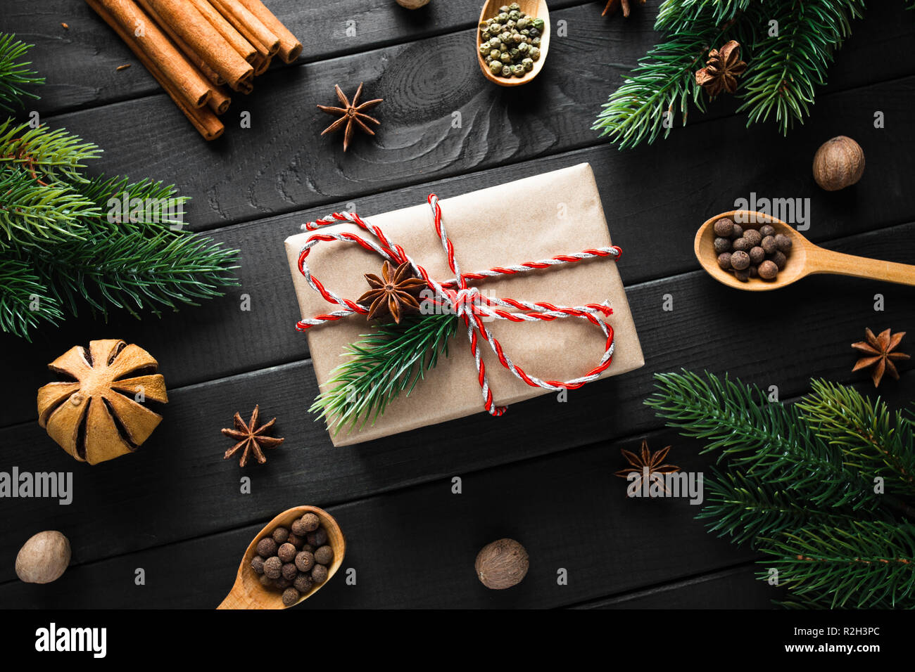 Vintage gift box with christmas decoration on dark wooden background. Stock Photo