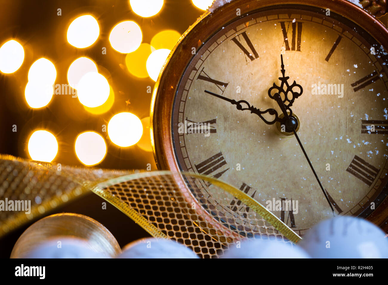 New Years clock and white balls covered with lights Stock Photo