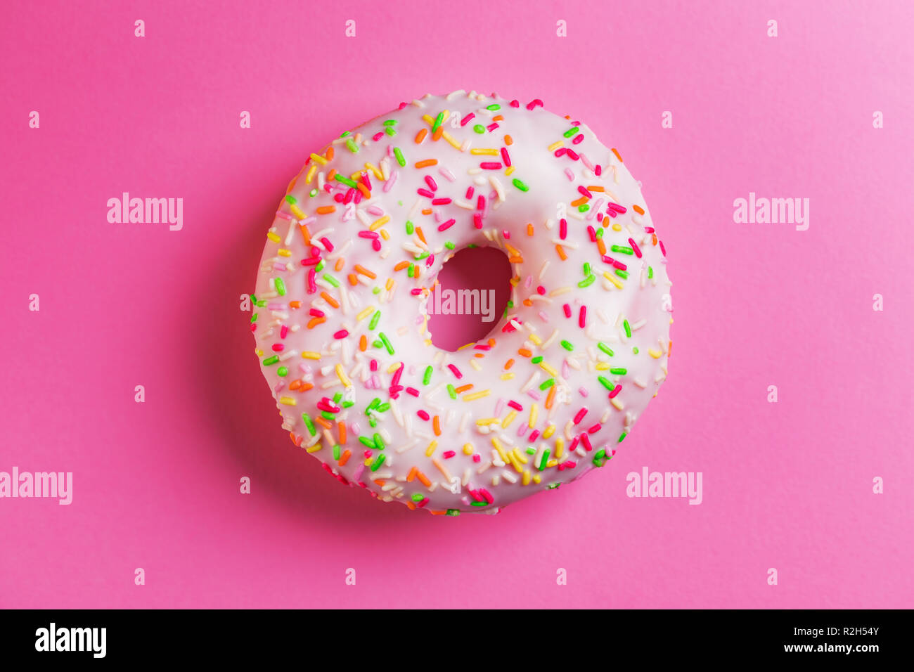 Single round donut on pink background. Stock Photo