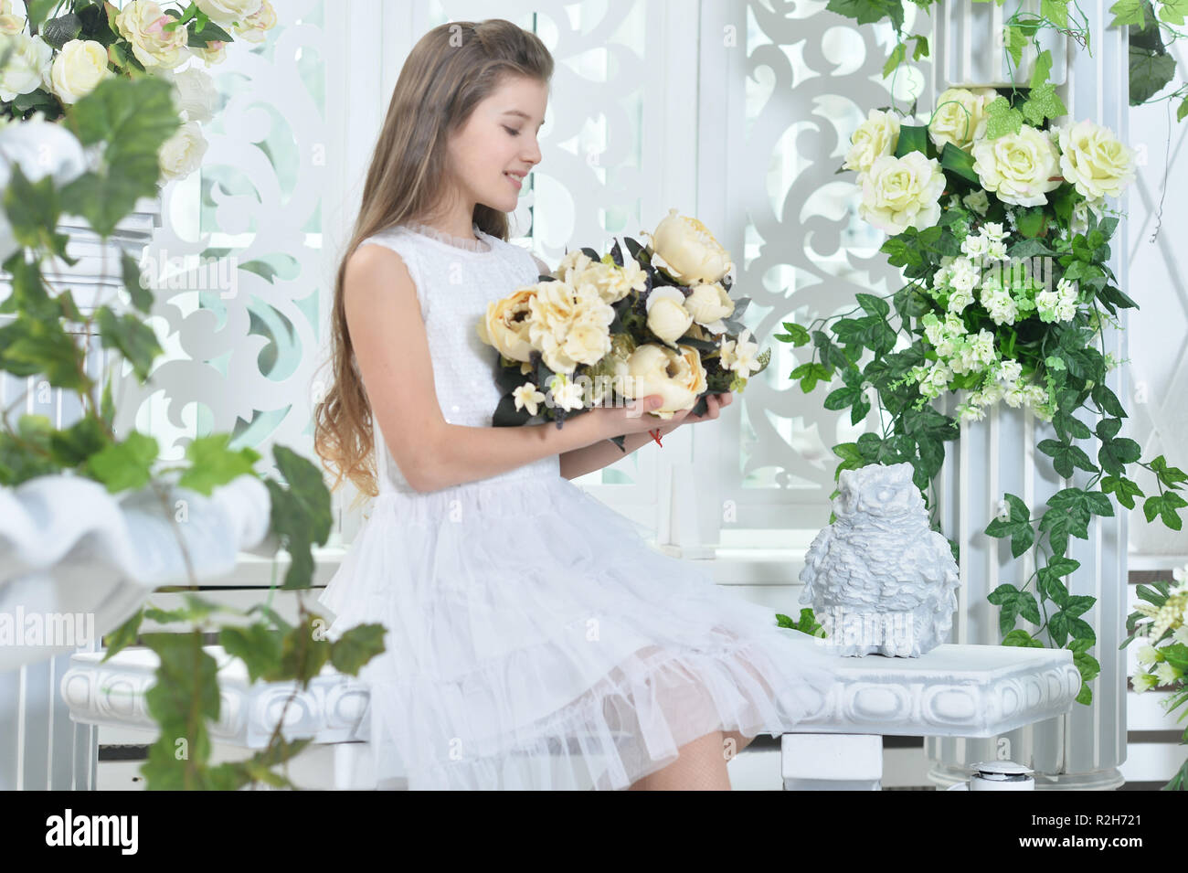 Happy little girl in white dress posing Stock Photo - Alamy