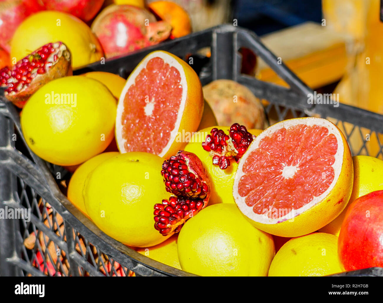 Closeup of sliced colorful fresh fruit, grapefruit and pomegranate at the streetmarket Stock Photo