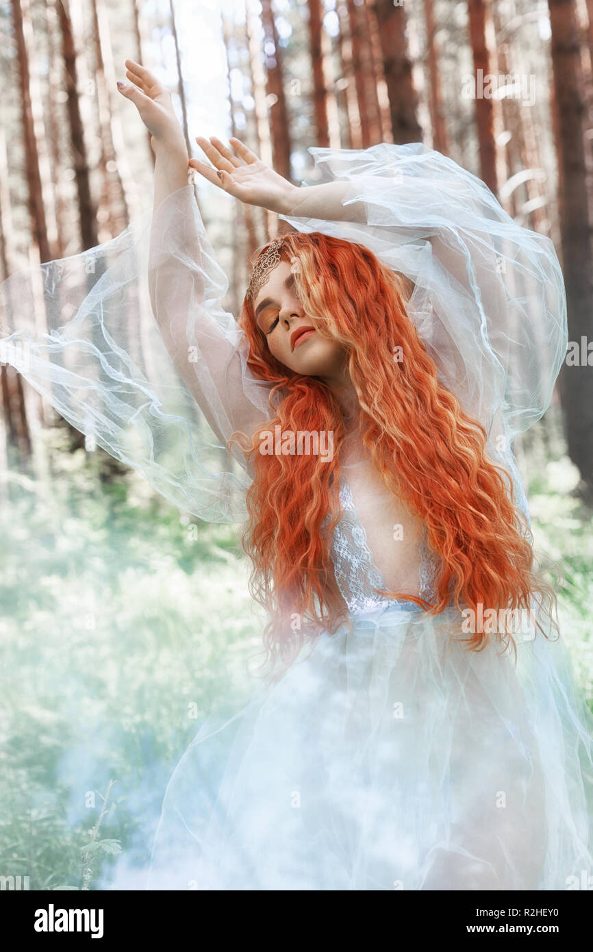 Beautiful Redhead Woman Forest Nymph In A Blue Transparent Light