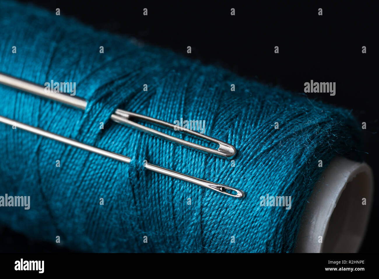 Spool with dark blue thread for sewing, supply for sewing, isolated object,  close-up macro with fine details, png on transparent background Stock Photo
