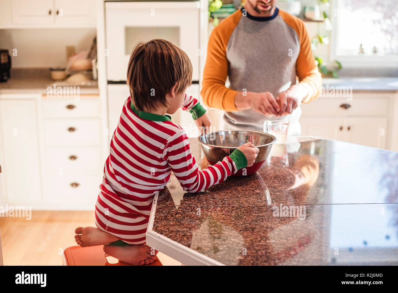 Boy helping his father bake in the kitchen Stock Photo - Alamy