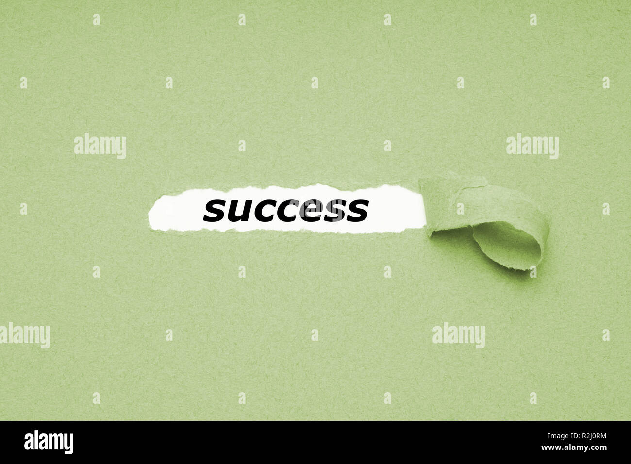 finding success concept - hole in paper background revealing hidden text Stock Photo
