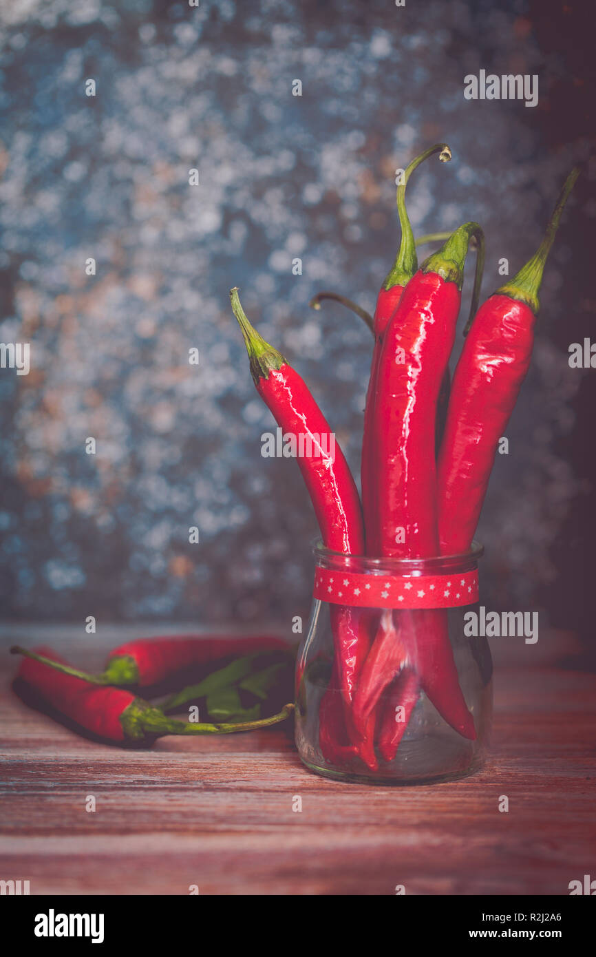 Spicy red chili peppers in a glass jar Stock Photo - Alamy