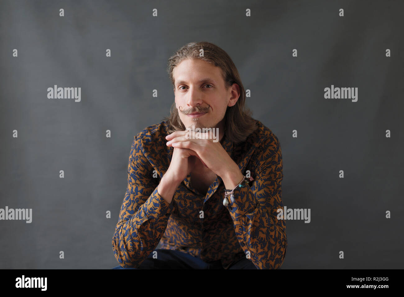 Portrait confident young man with handlebar mustache Stock Photo