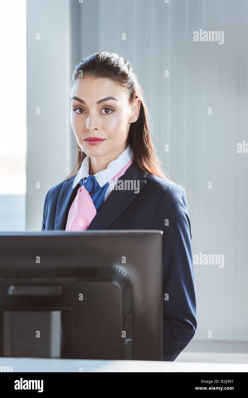 adult female airport worker standing at checkin desk Stock Photo Alamy