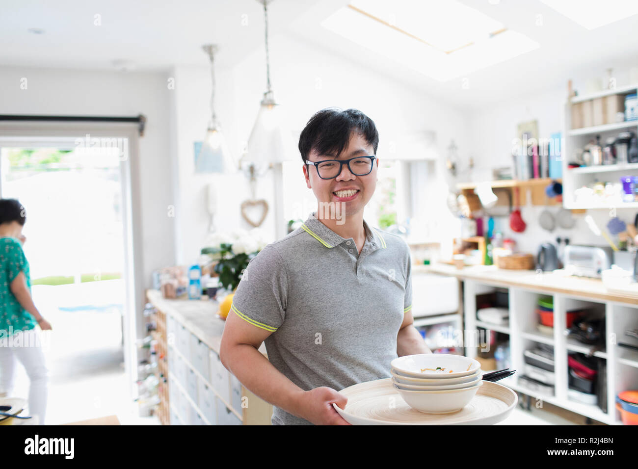Portrait smiling man doing dishes in kitchen Stock Photo