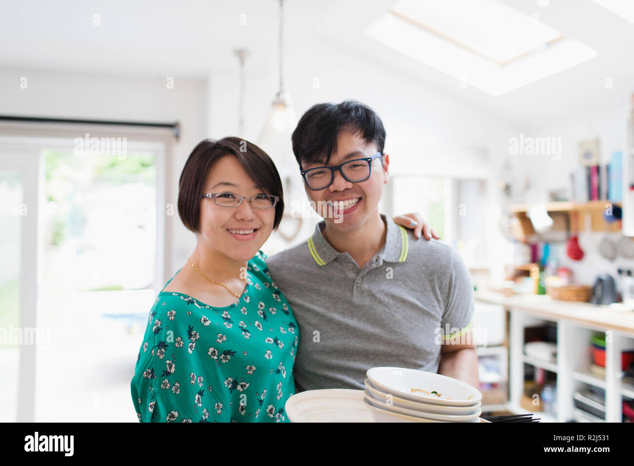 Portrait happy couple in kitchen Stock Photo