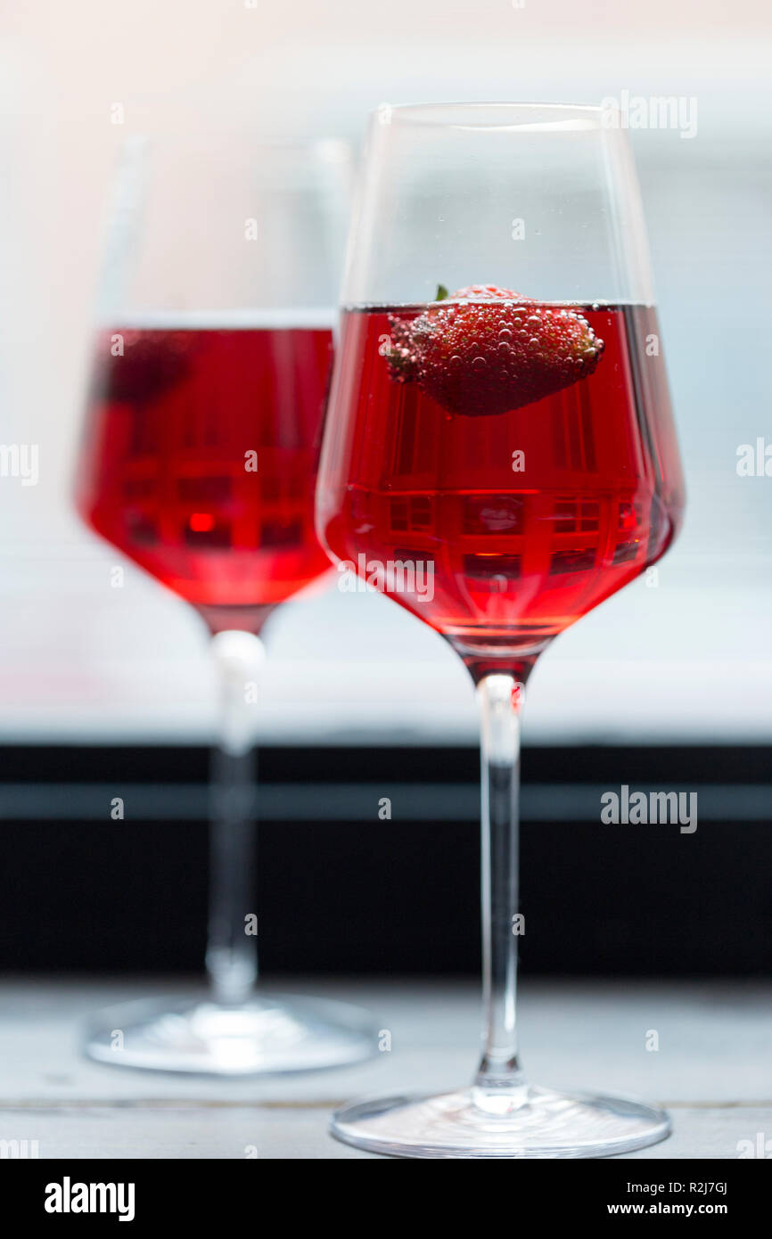 Romantic composition. Strawberry in pink champagne in glasses Stock Photo