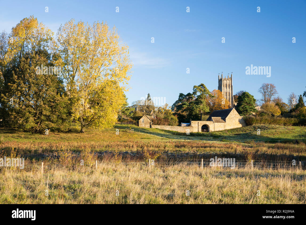 St James' church in morning sunlight with autumn trees, Chipping Campden, Cotswolds, Gloucestershire, England, United Kingdom, Europe Stock Photo