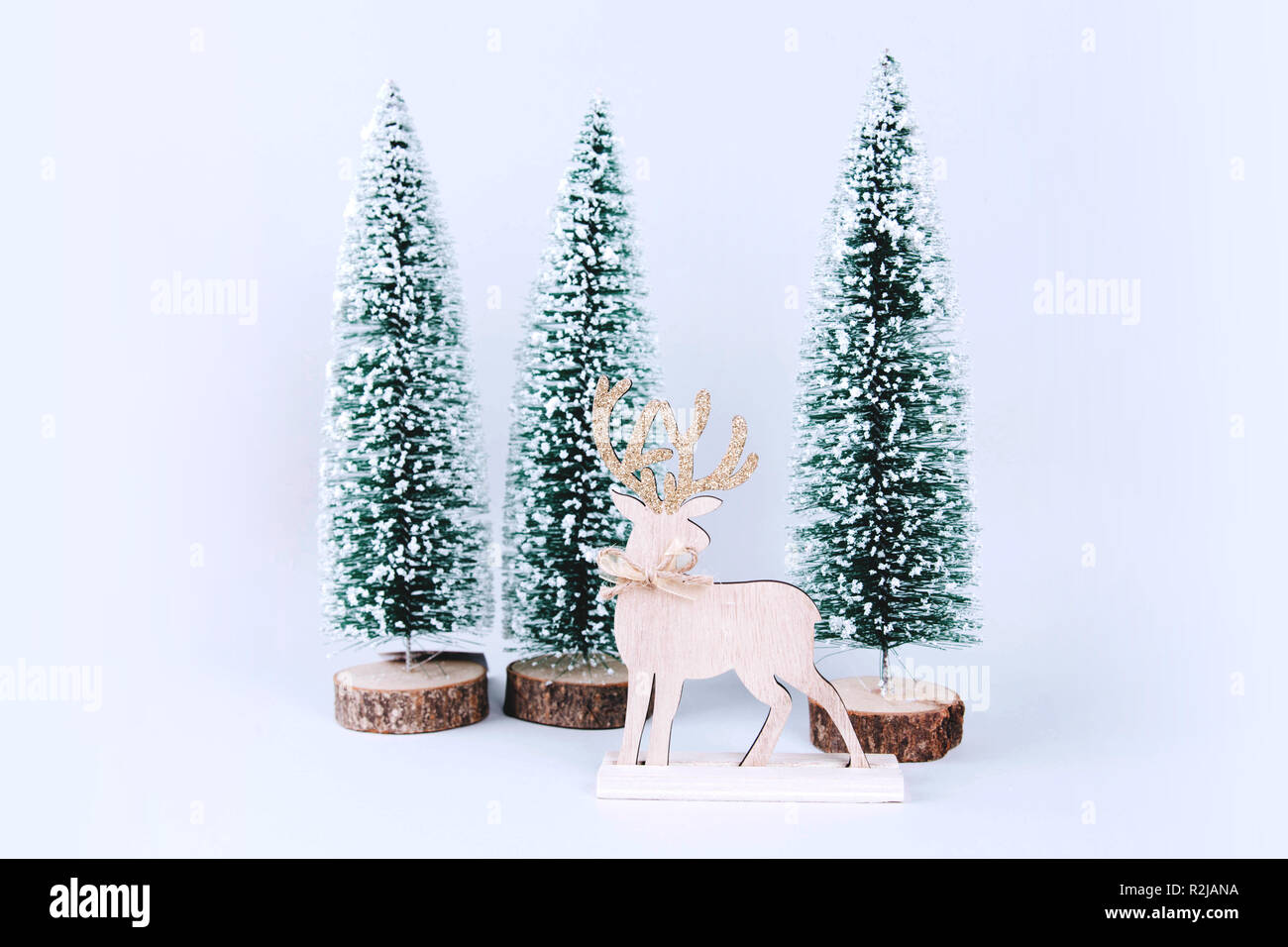 Christmas wooden tree with reindeer over light blue background Stock ...
