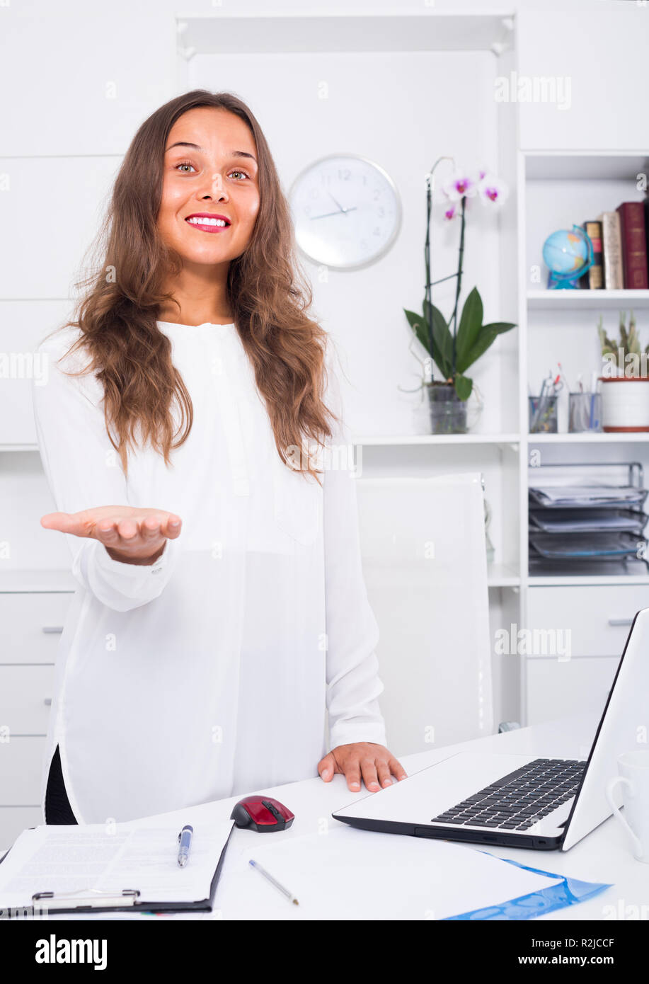 happy young business woman standing with desk in office Stock Photo - Alamy
