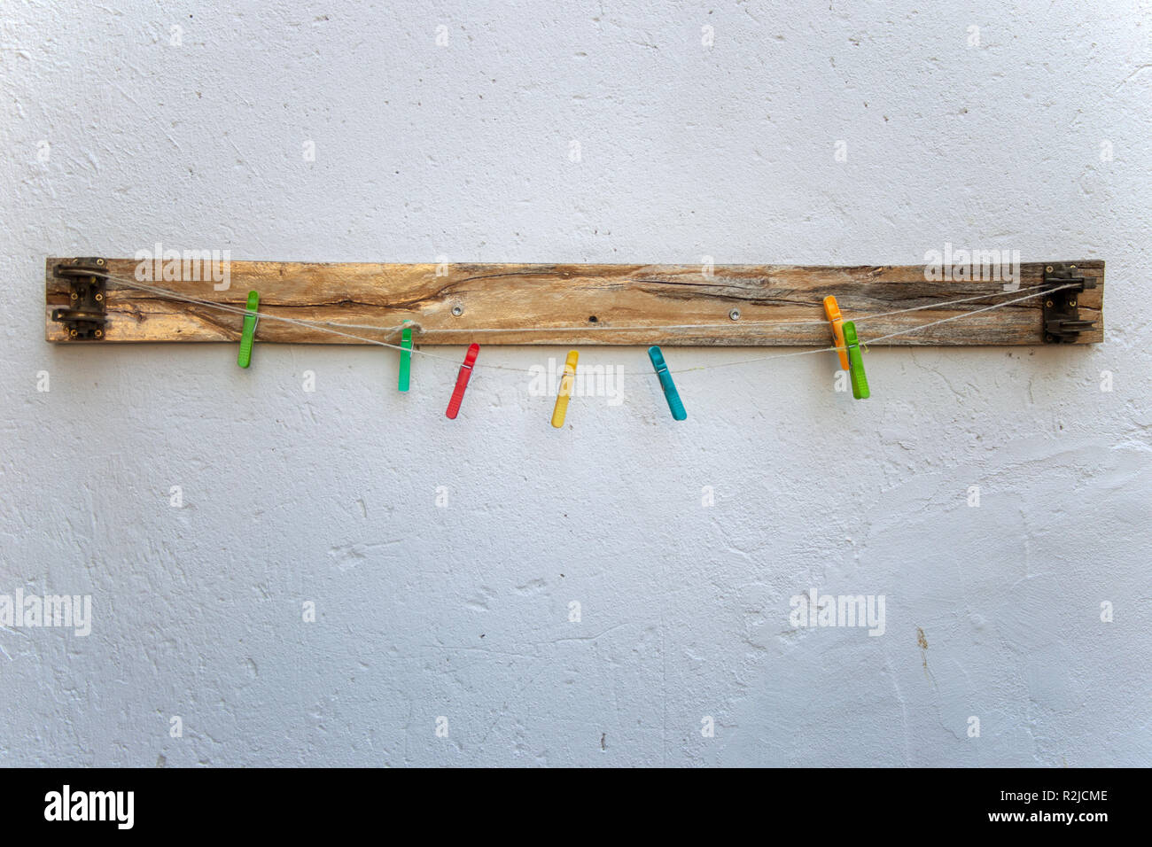 Plastic colorful laundry clips on rope on the background Stock Photo ...