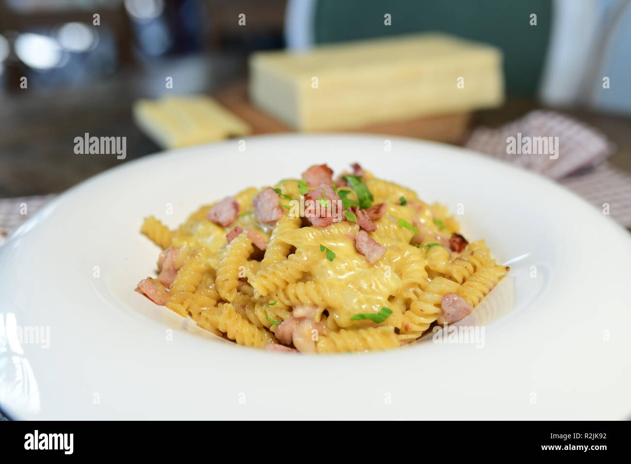 Fusilli pasta with bacon and goat cheese Stock Photo Alamy